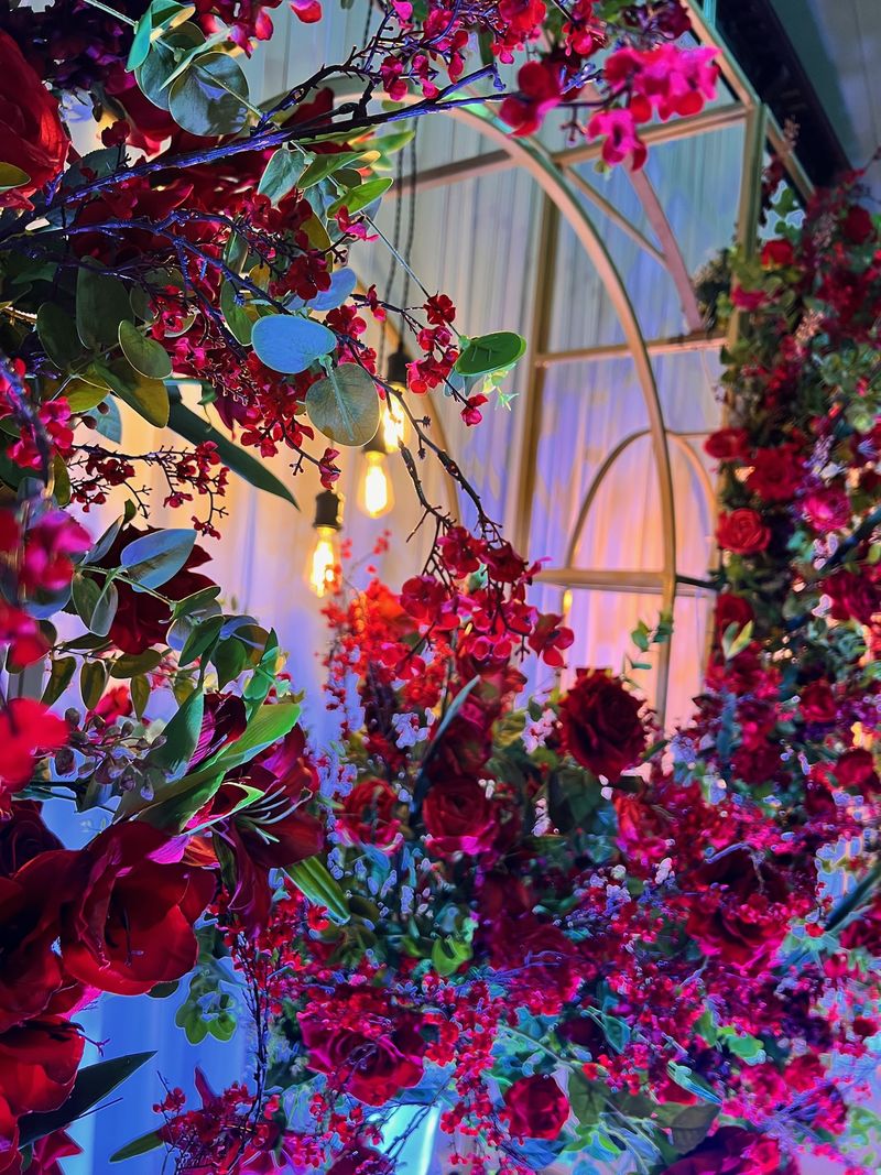 Dense magenta and red florals built around a gold hoop