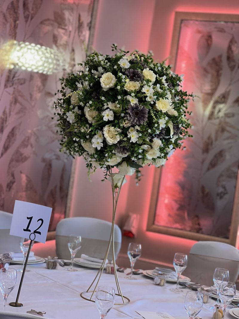 A floral sphere suspended above a dining table