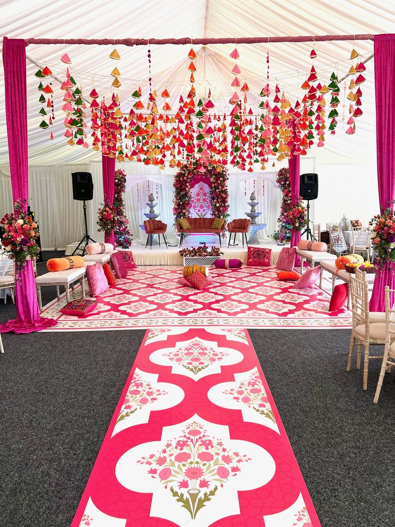Magenta drapes with a floral canopy over a patterned floor
