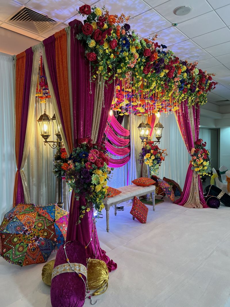 A floral arch over low seating and a patterned floor