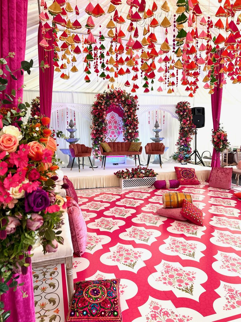 A dense floral canopy above pink drapes