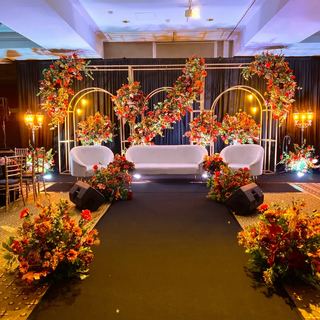 An amber-lit arch with floral panels in a softly lit hall