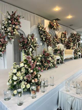 Florals carried along a draped structure above a long table