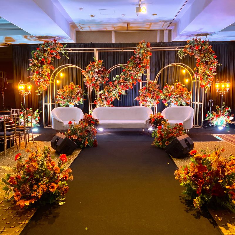 An amber-lit arch with floral panels in a softly lit hall