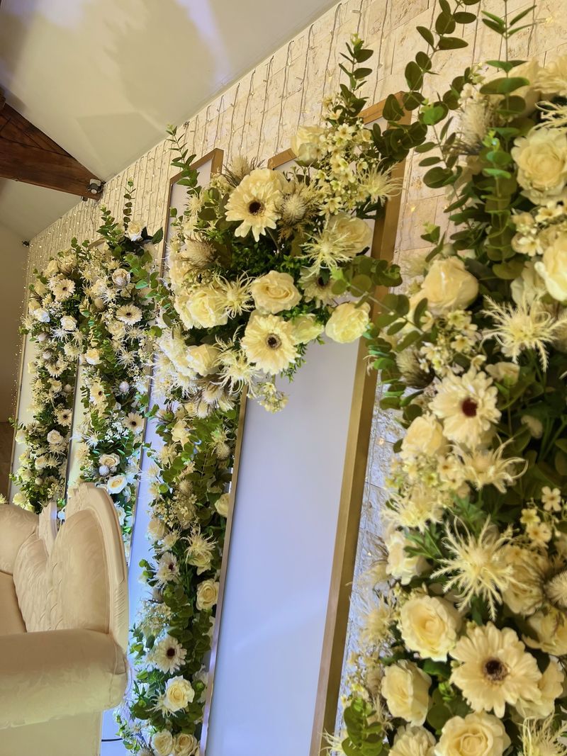 White floral columns framing a mirrored panel